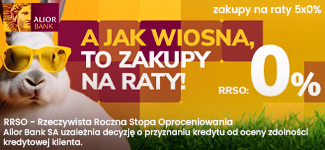Poziomy baner Alior Banku z białym królikiem w żółtych okularach na tle trawy. Tekst promuje zakupy na raty 5x0% z RRSO 0% w wiosennej kampanii. W górnym rogu widnieje bordowe logo Alior Bank.