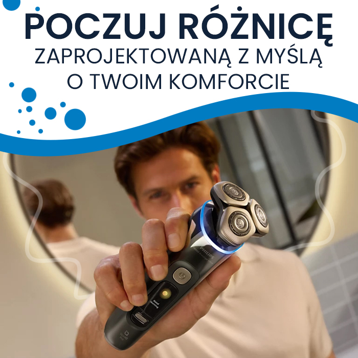 Reklamowy baner z hasłem o komforcie, przedstawiający mężczyznę trzymającego golarkę Philips S9000 Prestige w stronę widza. Urządzenie ma srebrne detale, niebieskie podświetlenie pod głowicami i wyświetlacz z napisem Good morning. W tle widać łazienkę z okrągłym lustrem.