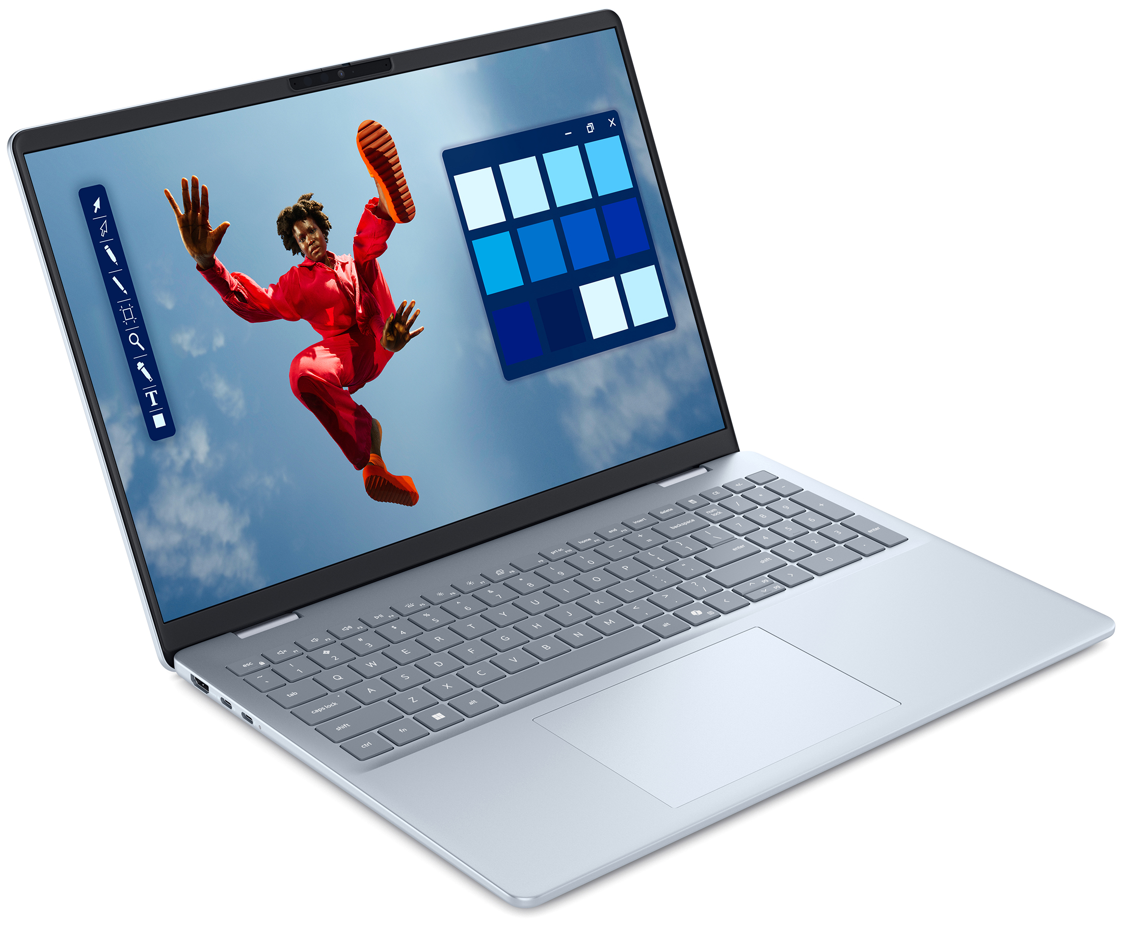 Srebrzystoszary laptop Dell 16 Plus 9052BLU z otwartym ekranem na białym tle, widziany pod kątem z prawej strony. Na wyświetlaczu działa program graficzny z postacią w czerwonym stroju, panelem narzędzi i paletą odcieni niebieskiego.