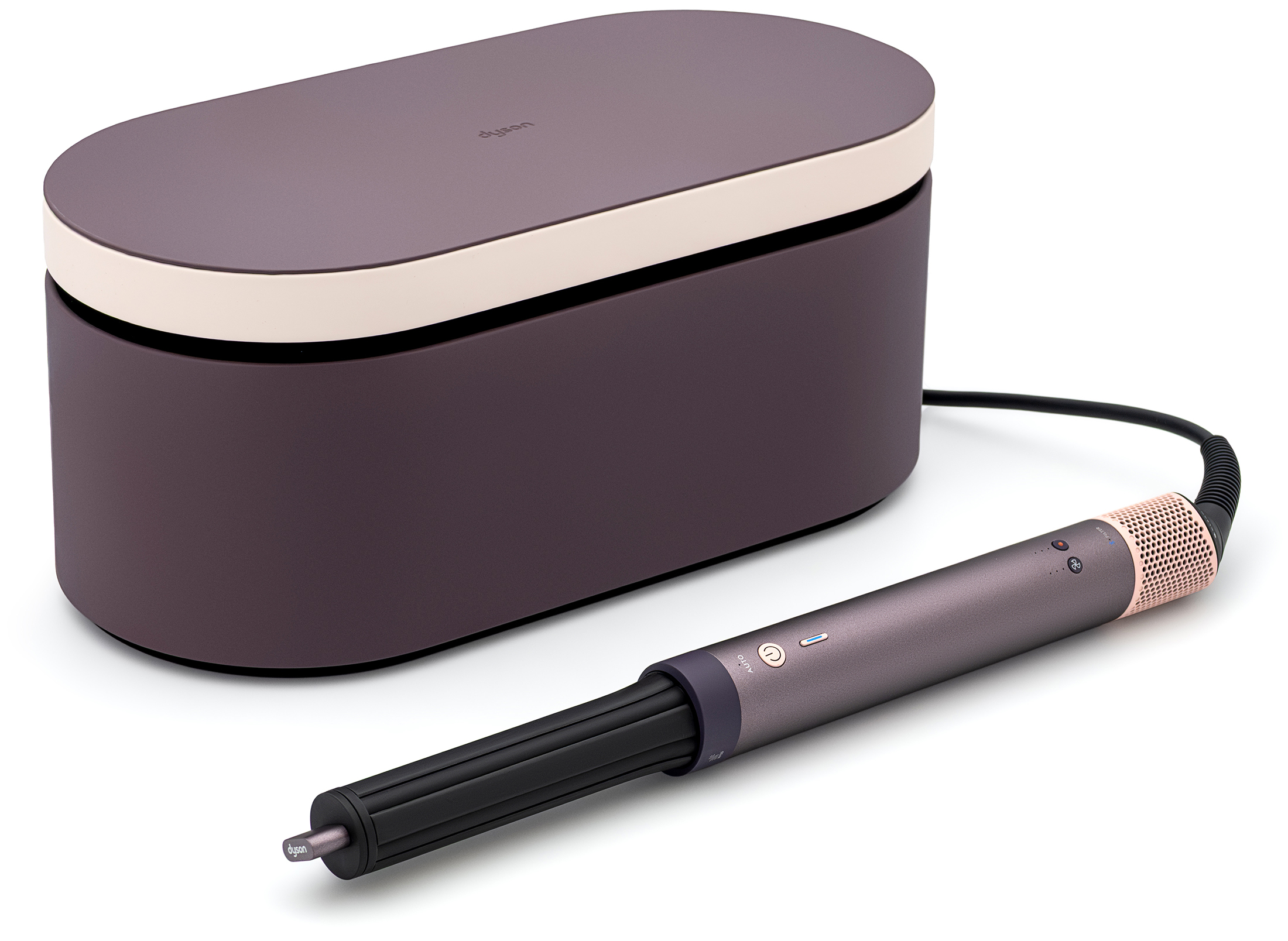 Lokówko-suszarka Dyson Airwrap Multistyler w kolorze fioletowego jaspisu leży obok pasującego, owalnego etui. Urządzenie posiada matową fioletową rączkę z akcentami różowego złota oraz czarną końcówkę stylizującą.