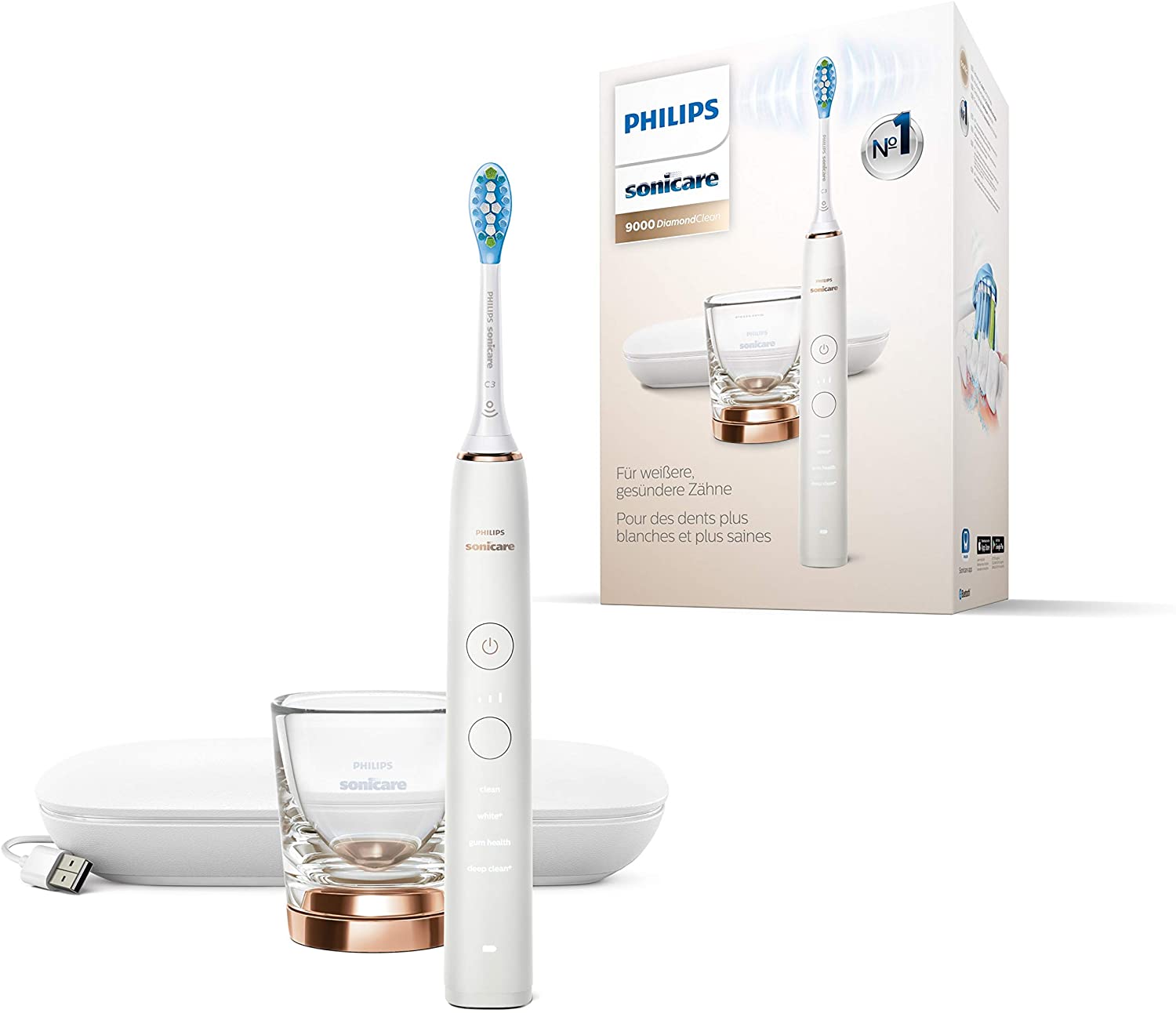 Zestaw Philips Sonicare 9000 DiamondClean HX9911/94 prezentowany obok fabrycznego opakowania. Na białym tle widoczna szczoteczka, szklanka z różowozłotą podstawą oraz etui podróżne z kablem USB.
