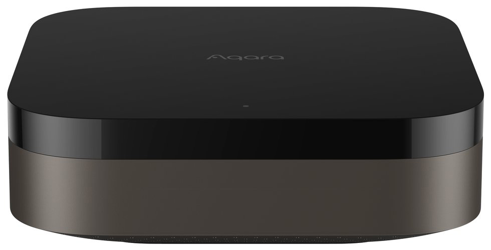 Jednostka centralna Aqara Hub M3 w widoku od frontu na białym tle. Urządzenie charakteryzuje się nowoczesnym, warstwowym designem w kolorach czarnym i ciemnoszarym z zaokrąglonymi krawędziami oraz dyskretnym logo na górnej pokrywie.