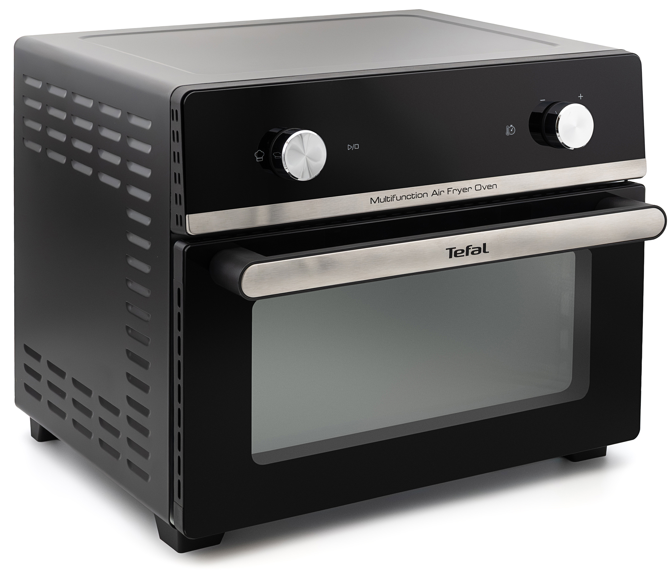 Czarny piekarnik Tefal Multifunction Air Fryer Oven z metalowymi detalami i szklanym frontem na białym tle. Widok z boku ukazuje otwory wentylacyjne, dwa srebrne pokrętła sterujące na panelu oraz logo Tefal na szerokim uchwycie.