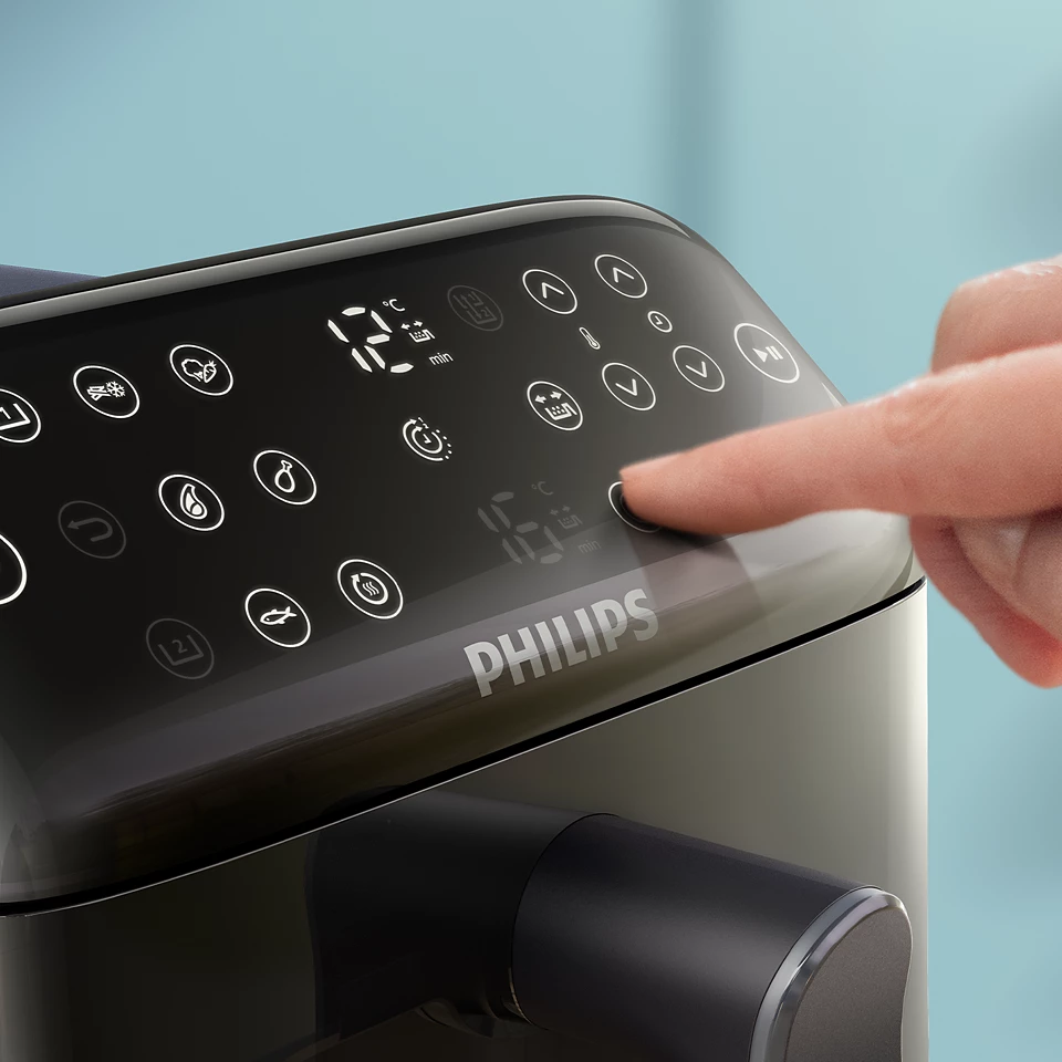 Intuicyjny panel sterowania frytkownicy Philips Airfryer. Cyfrowy wyświetlacz pokazuje niezależne ustawienia czasu dla obu komór, a dotykowe ikony pozwalają na szybki wybór dedykowanych programów kulinarnych.