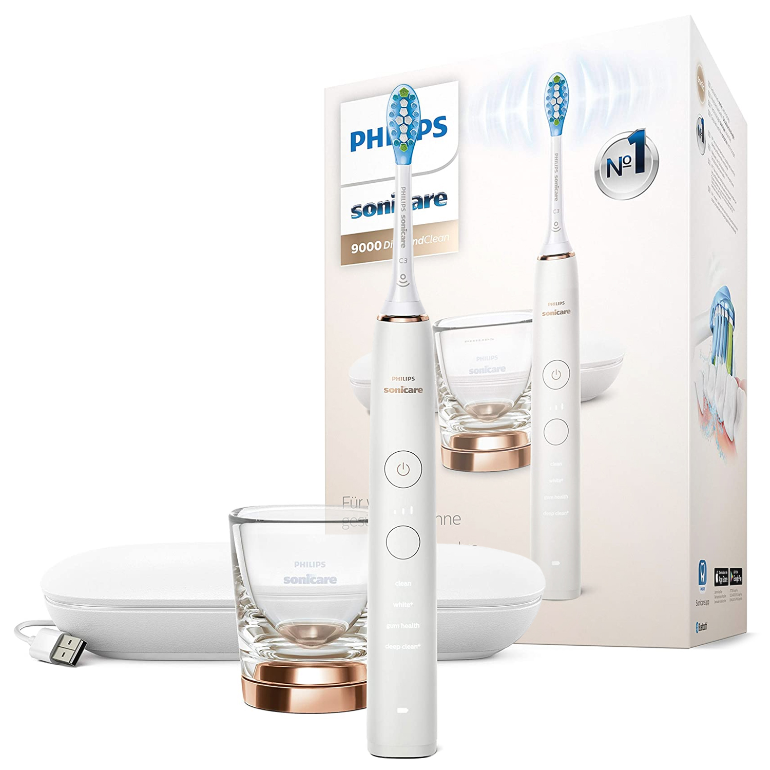 Szczoteczka soniczna Philips Sonicare 9000 DiamondClean w kolorze białym ze szklanką ładującą i etui podróżnym na tle fabrycznego opakowania. Urządzenie posiada eleganckie wykończenia w kolorze różowego złota i czytelny panel z trybami pracy.