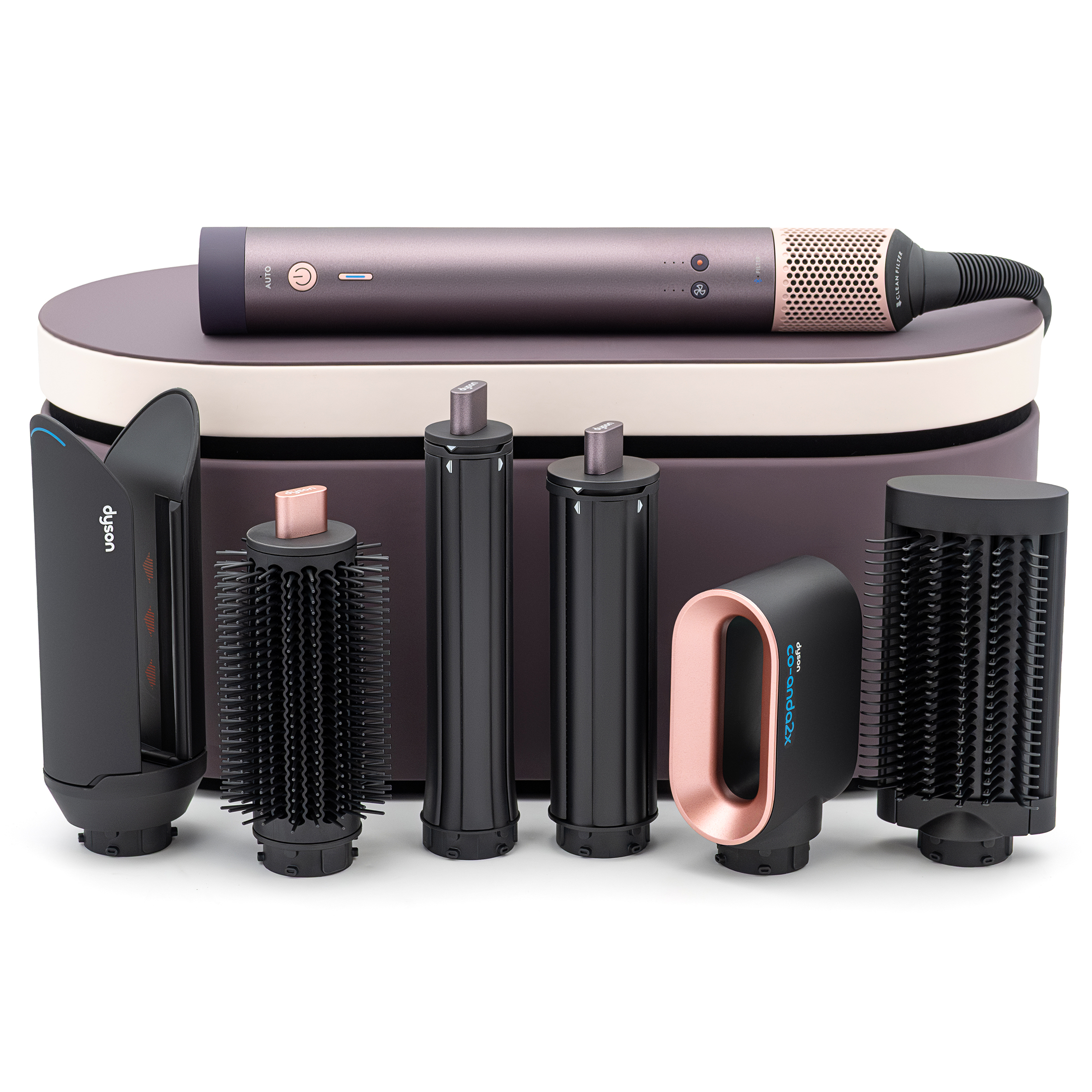 Zestaw Dyson Airwrap Multistyler w kolorze fioletowego jaspisu. Główny moduł urządzenia spoczywa na etui, a obok niego ustawiono w rzędzie sześć wymiennych końcówek do stylizacji, w tym nasadkę Co-anda i szczotki.